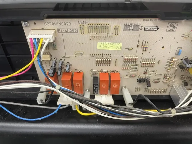 Appliance console control board with relays and wiring exposed