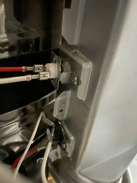 Thermostat and wiring on a dryer housing